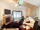 Open living room featuring hardwood floors, a fireplace, comfortable seating, and high ceilings at 5500 Fortunes Ridge Dr # 94C, Durham, NC 27713