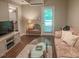 Bright living room with natural light, hardwood floors, and comfortable seating at 5500 Fortunes Ridge Dr # 94C, Durham, NC 27713
