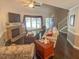 Bright living room with hardwood floors, fireplace, comfortable seating, and an open staircase at 5500 Fortunes Ridge Dr # 94C, Durham, NC 27713