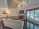Cozy living room featuring a fireplace, hardwood floors, high ceilings, and large windows at 5500 Fortunes Ridge Dr # 94C, Durham, NC 27713