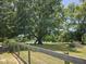 Fenced backyard featuring mature trees and plenty of room for outdoor activities at 56 Sugarhill Dr, Zebulon, NC 27597