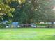Large, grassy backyard is partially enclosed by a wooden fence, perfect for outdoor activities at 56 Sugarhill Dr, Zebulon, NC 27597