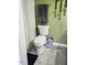 This bathroom features a toilet, gray towel and neutral patterned floor mat at 56 Sugarhill Dr, Zebulon, NC 27597