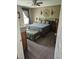 Comfortable bedroom with carpet flooring, soft natural light, and neutral wall tones at 56 Sugarhill Dr, Zebulon, NC 27597