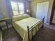 Cozy bedroom with a metal frame bed, neutral carpet and a window allowing natural light at 56 Sugarhill Dr, Zebulon, NC 27597