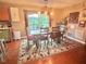 Bright dining area featuring a wooden table and chairs, a decorative rug, and sliding glass doors leading to the backyard at 56 Sugarhill Dr, Zebulon, NC 27597