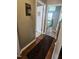 Hallway view with wood floors, a baby gate, and a bedroom visible at 56 Sugarhill Dr, Zebulon, NC 27597