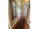 Hallway with wood floors, a mirror, and doors leading to other rooms at 56 Sugarhill Dr, Zebulon, NC 27597