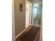 Hallway with wood floors leading to a bedroom, door to a bathroom and neutral walls at 56 Sugarhill Dr, Zebulon, NC 27597