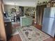 Open kitchen flows to dining area, featuring a versatile center island and stainless refrigerator at 56 Sugarhill Dr, Zebulon, NC 27597