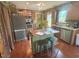 Inviting kitchen with a center island, stainless steel appliances, and an exterior door at 56 Sugarhill Dr, Zebulon, NC 27597