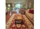 Inviting living room area with a decorative rug, coffee table, comfortable seating, and an open view of the dining area at 56 Sugarhill Dr, Zebulon, NC 27597