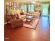 Cozy living room featuring hardwood floors, comfortable seating, a decorative rug, and plenty of natural light at 56 Sugarhill Dr, Zebulon, NC 27597