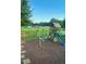 Backyard features a play set with swings, a slide, and a playhouse for outdoor fun at 56 Sugarhill Dr, Zebulon, NC 27597