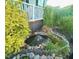 Lush landscaping surrounds a tranquil water feature adding charm to the exterior space at 56 Sugarhill Dr, Zebulon, NC 27597