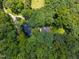Overhead shot of a wooded property with a small pond on premises at 6001 Waters Way Dr, Raleigh, NC 27606