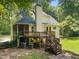 Exterior of home with wooden deck, screened-in porch and air conditioning at 6001 Waters Way Dr, Raleigh, NC 27606