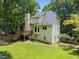 Rear exterior of a home featuring a wooden deck and a lush backyard at 6001 Waters Way Dr, Raleigh, NC 27606