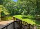 Wooden deck offers a scenic view of the private, wooded backyard at 6001 Waters Way Dr, Raleigh, NC 27606