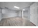 Finished basement features neutral paint, recessed lighting, and durable laminate flooring at 6001 Waters Way Dr, Raleigh, NC 27606