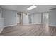 Finished basement with neutral paint, recessed lights, and grey laminate flooring at 6001 Waters Way Dr, Raleigh, NC 27606