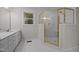 Bright bathroom featuring a glass enclosed shower, white tile, and a marble vanity top at 6001 Waters Way Dr, Raleigh, NC 27606