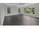 Bedroom with large windows offering natural light and views of the backyard landscaping at 6001 Waters Way Dr, Raleigh, NC 27606
