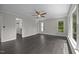 Large bedroom featuring hardwood floors, a ceiling fan, and multiple windows at 6001 Waters Way Dr, Raleigh, NC 27606