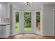 Bright breakfast nook with a bay window overlooking the backyard and hardwood floors at 6001 Waters Way Dr, Raleigh, NC 27606