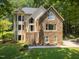 Charming home with stone facade, elegant windows, and inviting front steps at 6001 Waters Way Dr, Raleigh, NC 27606