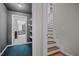 Hallway featuring neutral-colored walls, a door to an additional room, and stairs at 6001 Waters Way Dr, Raleigh, NC 27606