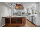 Spacious kitchen with stainless steel appliances, a custom island, and wood floors at 6001 Waters Way Dr, Raleigh, NC 27606