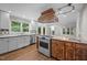 Large kitchen featuring stainless appliances, custom vent hood, and an open floor plan at 6001 Waters Way Dr, Raleigh, NC 27606