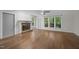 Living room with a stone fireplace and windows offering natural light at 6001 Waters Way Dr, Raleigh, NC 27606