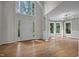 Spacious living room with hardwood floors, large windows and modern lighting fixtures at 6001 Waters Way Dr, Raleigh, NC 27606