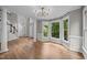 Open living room with large windows and view to staircase at 6001 Waters Way Dr, Raleigh, NC 27606