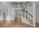 Elegant staircase with wood treads and railing, plus an upper level landing at 6001 Waters Way Dr, Raleigh, NC 27606