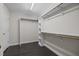 Walk-in closet with built-in shelving and clothing rods at 6001 Waters Way Dr, Raleigh, NC 27606