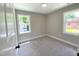 Bright bedroom with neutral walls, carpet, two windows, and white trim detail at 608 A E Umstead, Durham, NC 27701