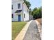 Gravel driveway leading to two-story home featuring black trim and a bright blue front door at 608 A E Umstead, Durham, NC 27701