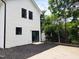 The exterior of this home features white siding and black window frames at 608 A E Umstead, Durham, NC 27701