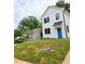 A two-story home featuring black trimmed windows and a bright blue front door on a well-manicured lawn at 608 A E Umstead, Durham, NC 27701