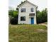 Charming two-story home features a bright blue front door, black trimmed windows, and well-manicured lawn at 608 A E Umstead, Durham, NC 27701