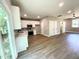 Modern kitchen featuring white cabinets, stainless steel appliances, and open access to the living room at 608 A E Umstead, Durham, NC 27701