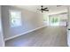 Bright living room with gray walls, gray flooring, a ceiling fan, and a view of the kitchen at 608 A E Umstead, Durham, NC 27701