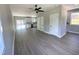 Spacious living room with gray walls, gray flooring, and access to a modern kitchen at 608 A E Umstead, Durham, NC 27701