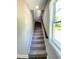 Carpeted stairway leading upstairs with natural light streaming through a nearby window at 608 A E Umstead, Durham, NC 27701