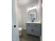 Contemporary half-bathroom features a stylish vanity with shaker cabinets and a shiplap accent wall at 608 E Umstead St, Durham, NC 27701