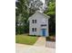 Charming two-story home featuring a bright blue front door, complemented by manicured landscaping and lush trees at 608 E Umstead St, Durham, NC 27701