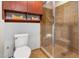 Well-maintained bathroom featuring glass shower, toilet, and built-in shelving at 618 N Boylan Ave # 520, Raleigh, NC 27603